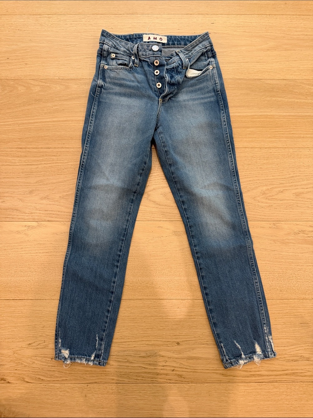 AMO Women's Faded Blue Skinny Jeans with Distressed Hem
